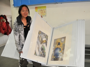Contemporary Inuit artist Suvinai Ashoona with two of her prints.